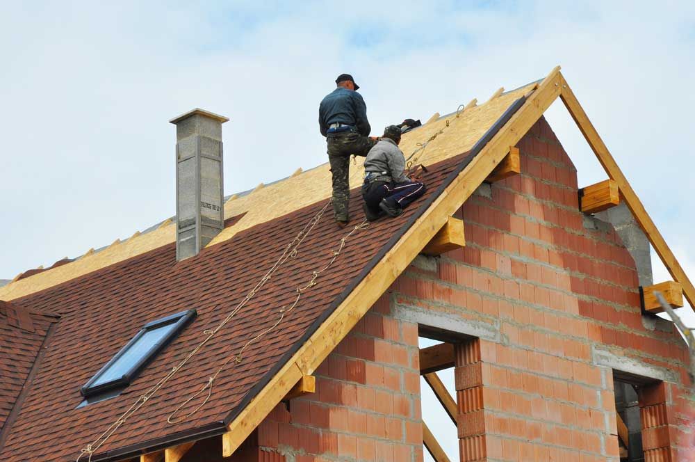 Roofers working on a roof deck during a replacement