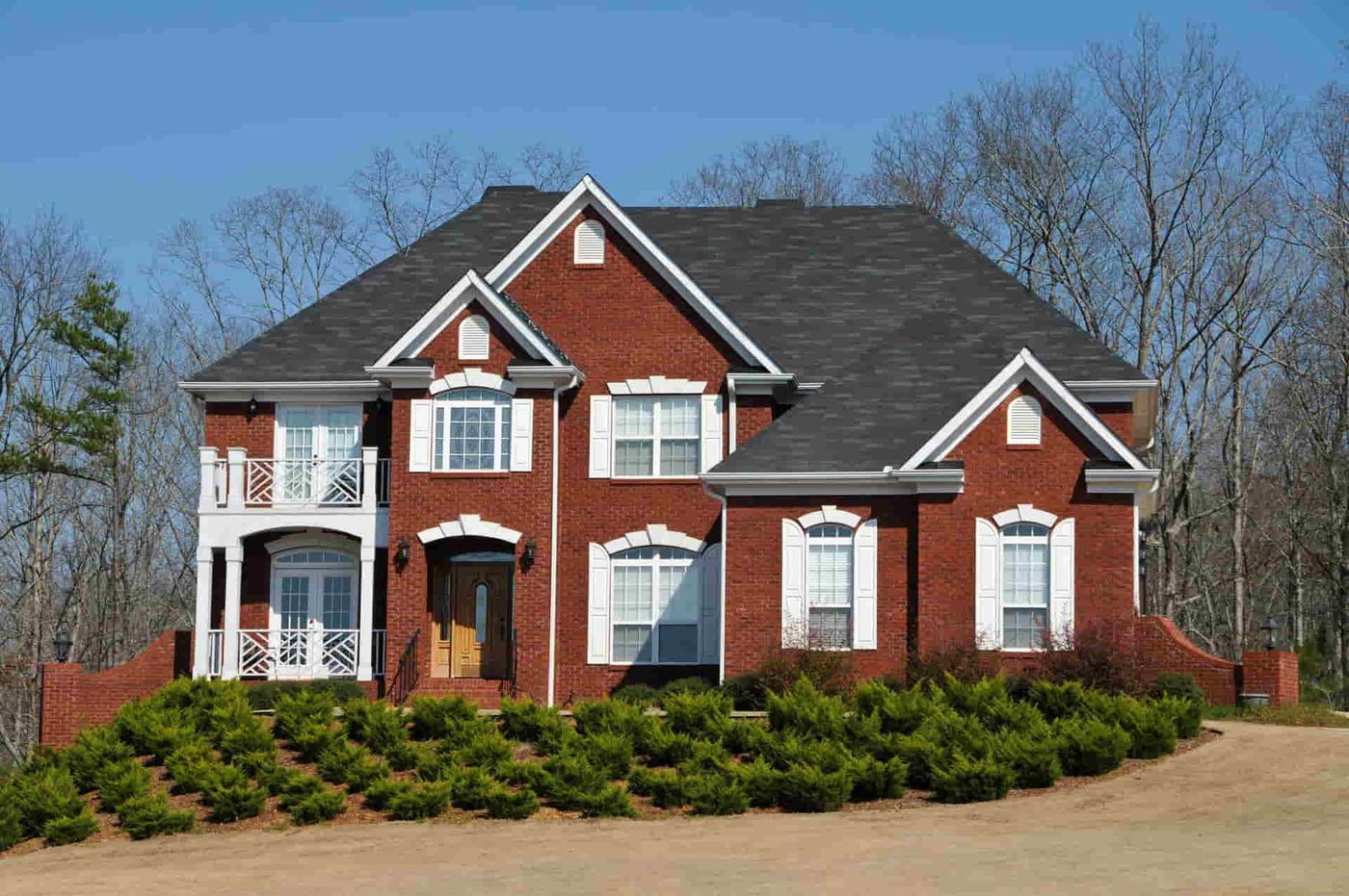 Red brick two-storey home with a shingle roof