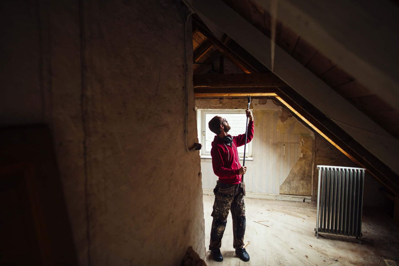 Homeowner adding insulation in an attic