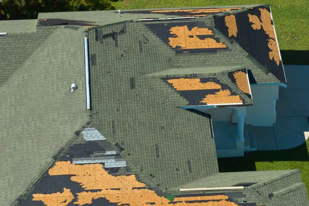 Infographic comparing wind uplift mechanics vs hail kinetic impact on residential roofs with damage patterns Infographic comparing wind uplift mechanics vs hail kinetic impact on residential roofs with damage patterns