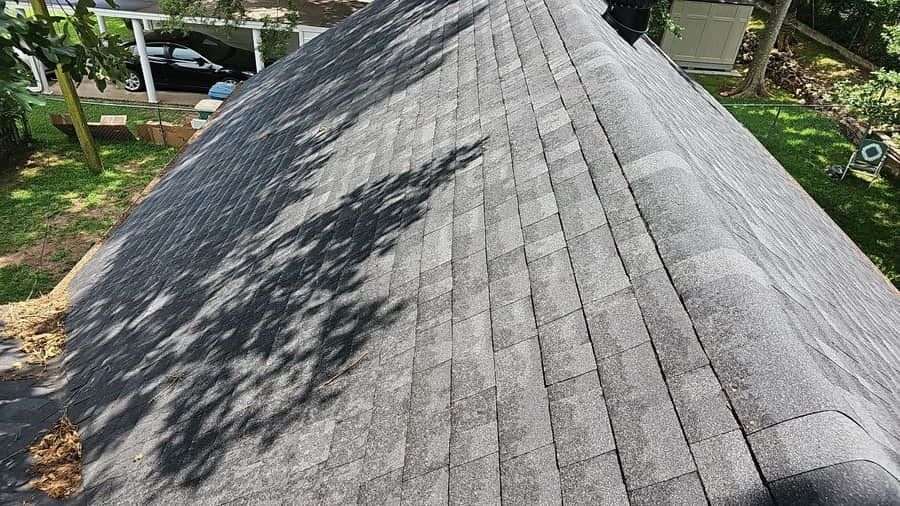 Aging 3-tab asphalt shingles on a residential roof