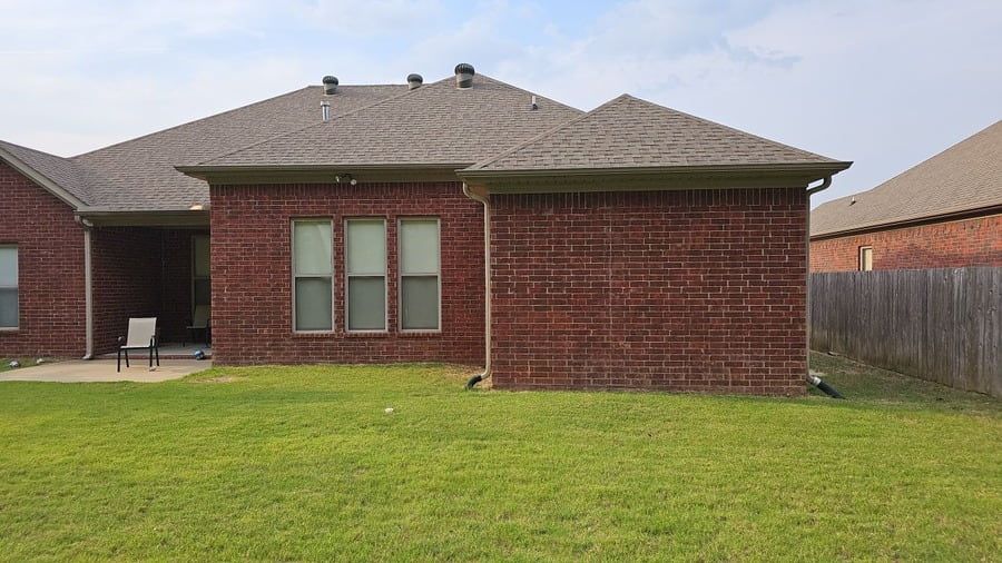 Single-storey brick home with an asphalt shingle roof