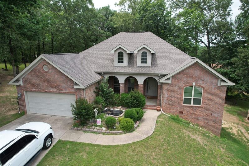 Brick two-storey home with a completed asphalt shingle roof