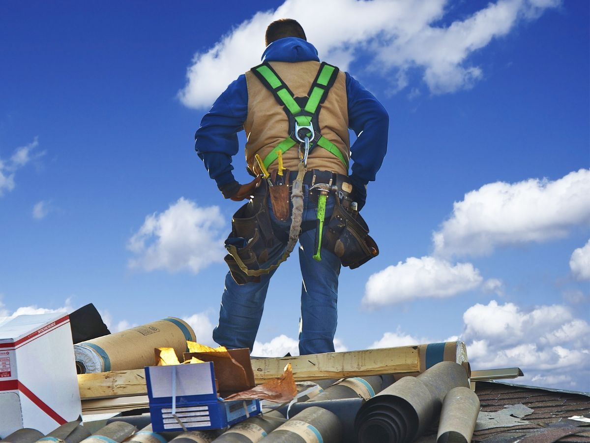 Roofer on site preparing for metal roofing work