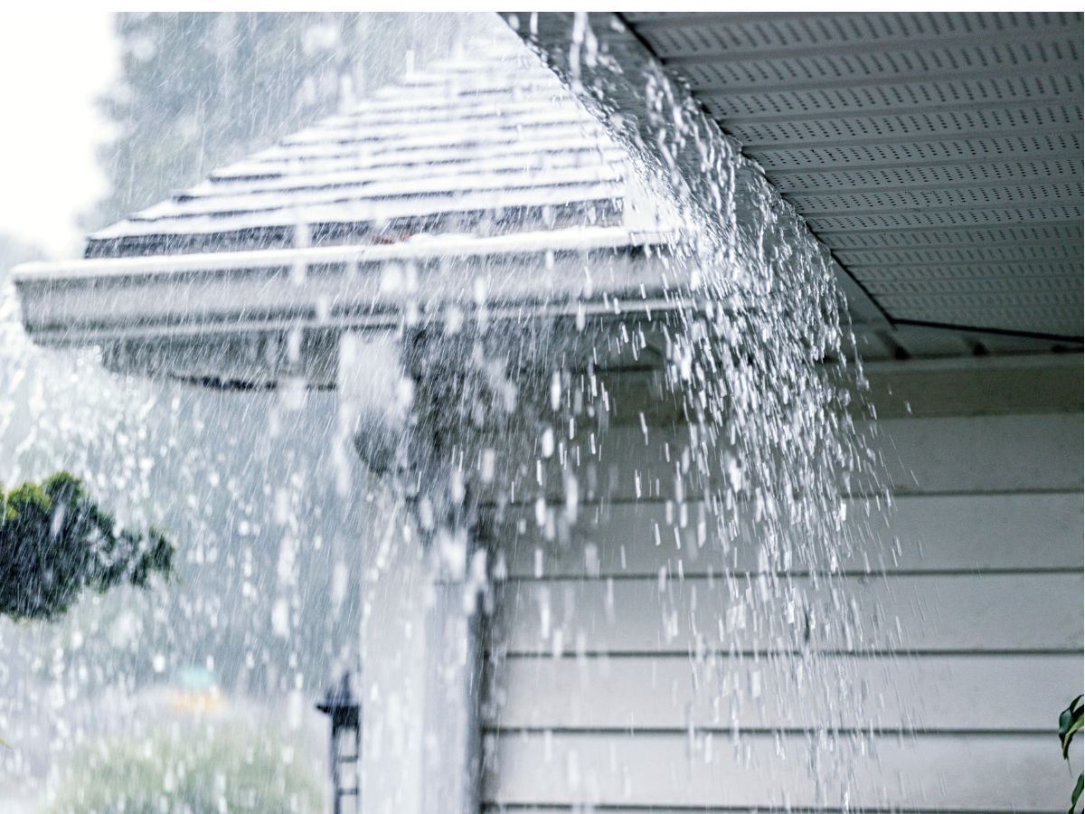 Heavy rain damaging the gutter and reducing roof's lifespan