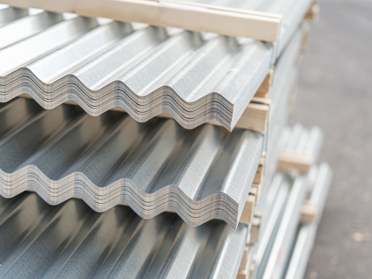 Stacked corrugated metal roofing panels on site