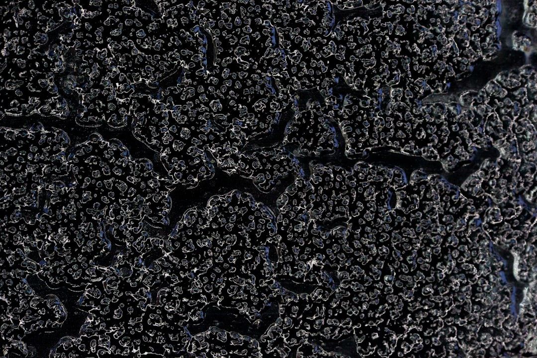 Sun-damaged asphalt shingles showing severe granule loss and curling Sun-damaged asphalt shingles showing severe granule loss and curling