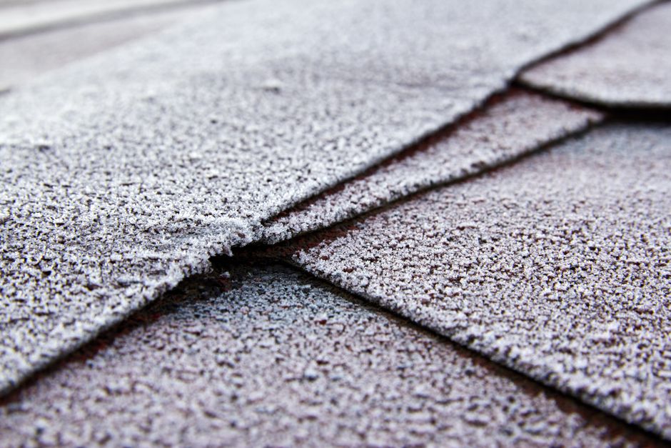 hail-damaged shingles on an Arkansas home showing granule loss and bruising