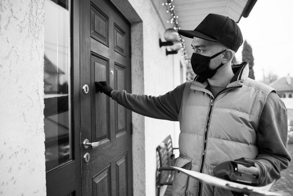 Uninvited contractor knocking on a homeowner's front door after a storm