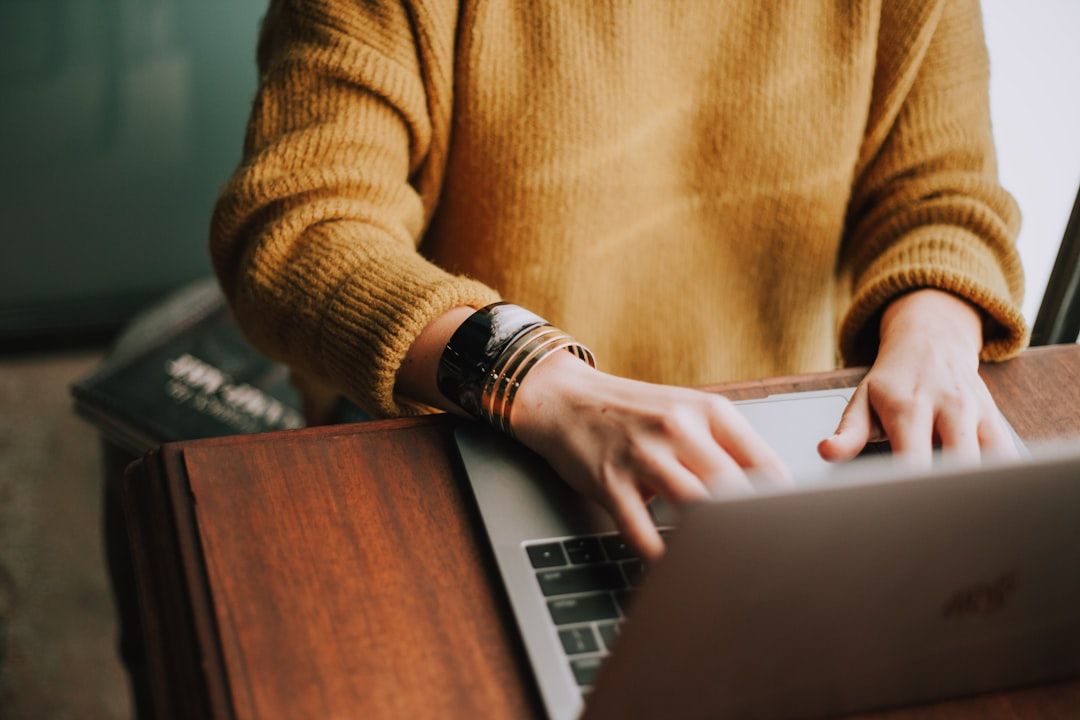 Homeowner using a laptop to search the Arkansas contractor database